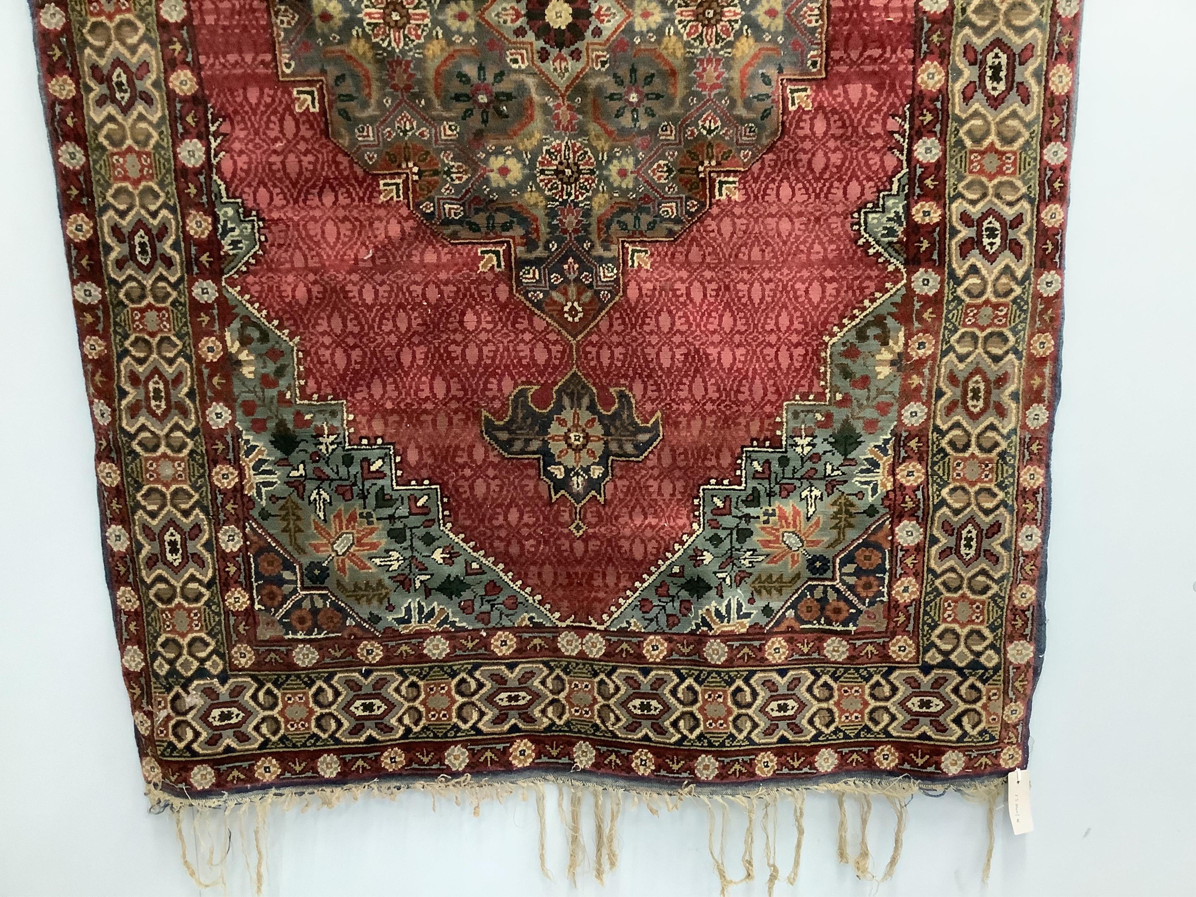 A North West Persian red ground rug, 170 x 106cm. Condition - faded and worn at the fringes